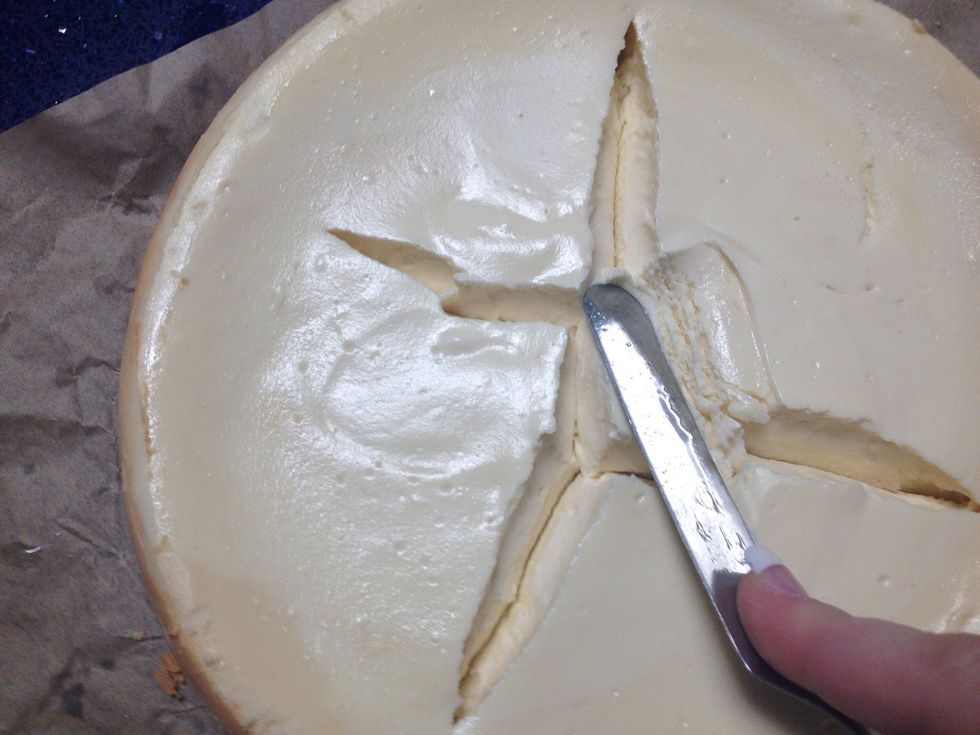 Dip your icing spreader in the water again and push down the cracks on the cake towards the other cracks.