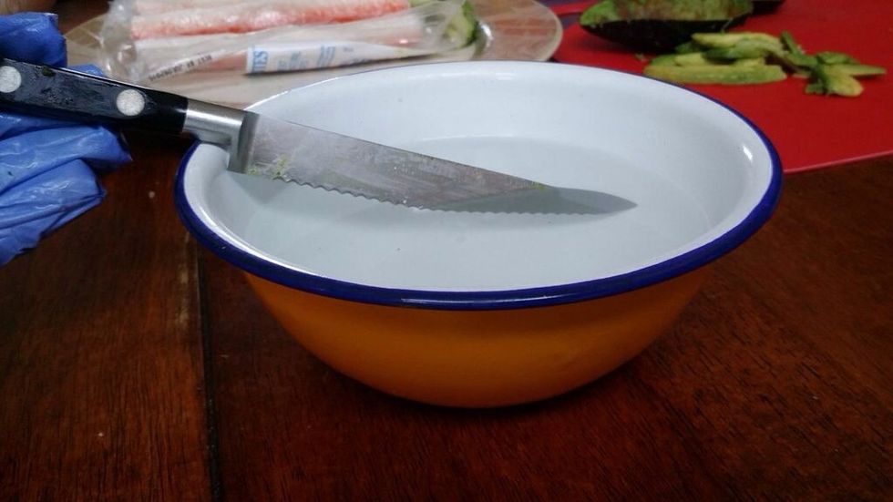 Dip your knife into your bowl of water. This makes it easier to cut through the seaweed when you start cutting your sushi.