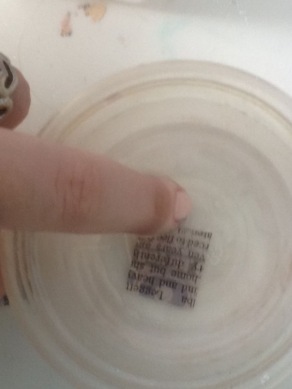 Dip your nail and the newspaper into the rubbing alcohol-make sure they are both completely wet