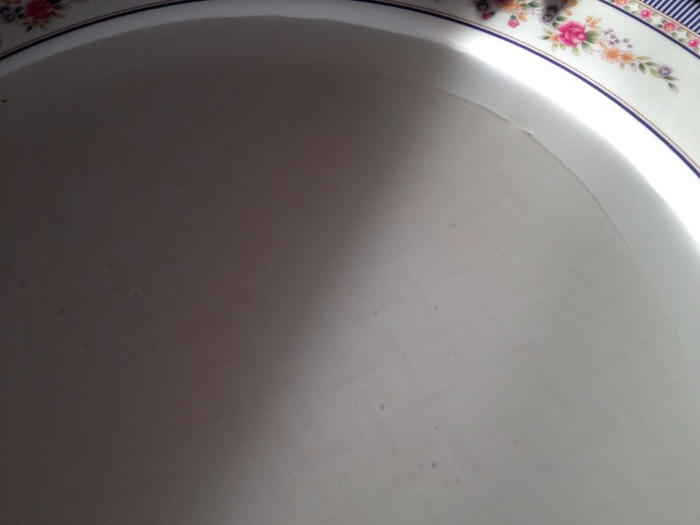 Dip your rice paper in a dish of warm water. Flip it to the other side. It may curl at first, just keep your hand spread out over it.