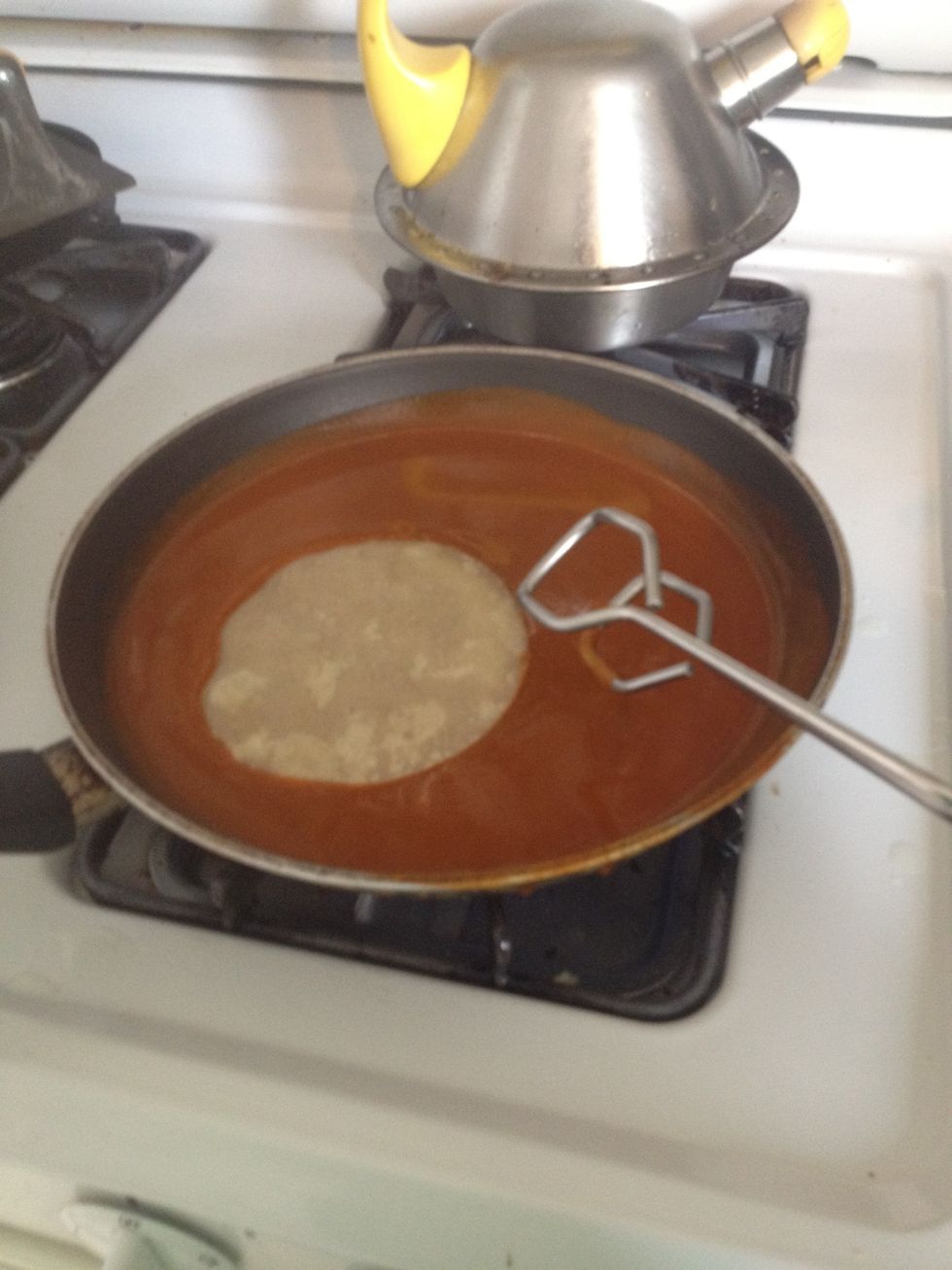 Dip your tortillas in the heated enchilada sauce, one at a time.