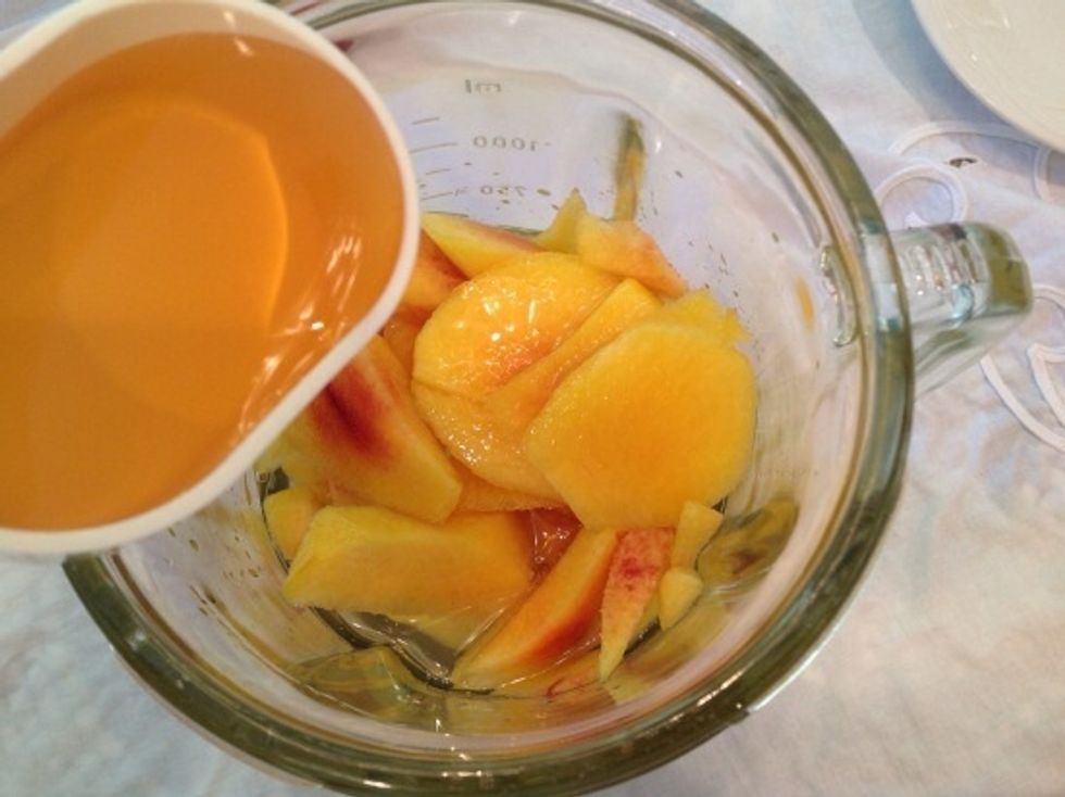 Discard skin and pits and transfer peaches to a blender. Add water, apple juice, honey, lime zest and juice, salt and pepper.