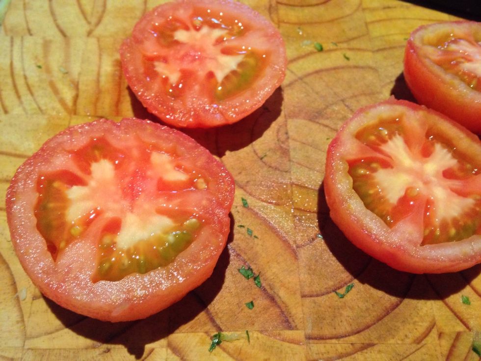 Discard the seeds and finely dice the tomatoes. Mix with one onion finely diced, add the juice and zest of one orange, and half the parsley. Add a splash of vinegar and salt and pepper.