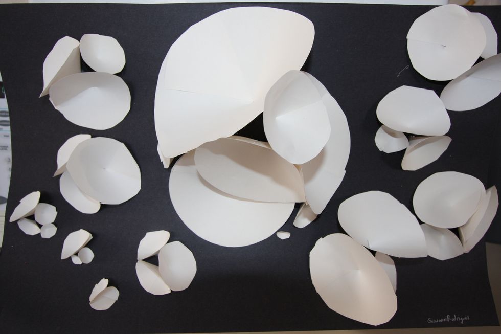 Display under a strong light source that will emphasize the  three dimensionality of the work.