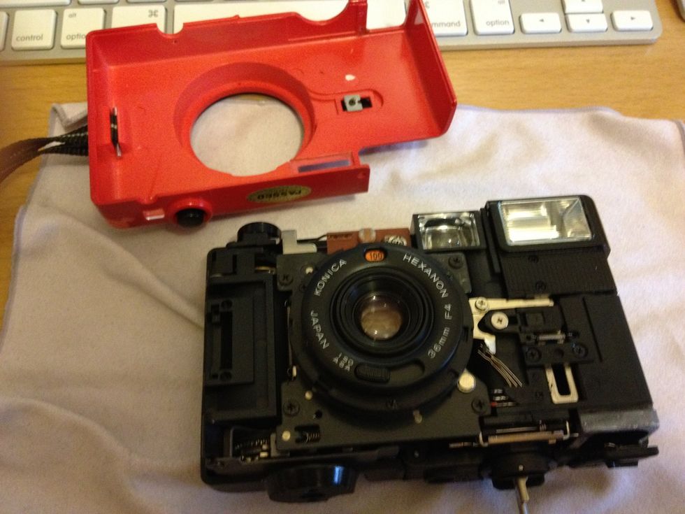 Dissemble the old camera and take the lens (with its bezel) out