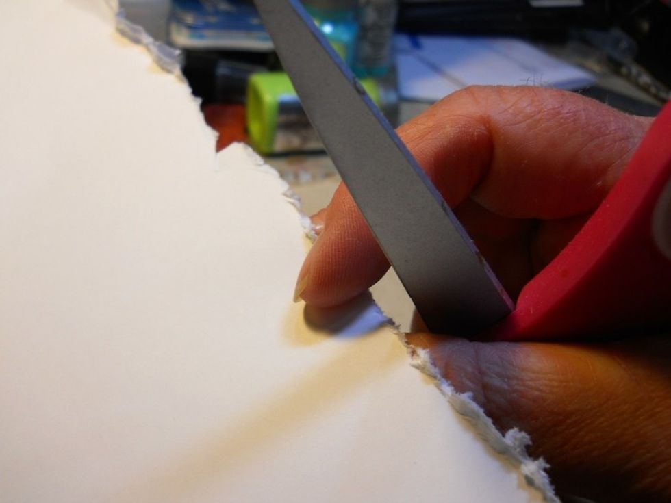 Distress the edges by using the edge of a pair of scissors.