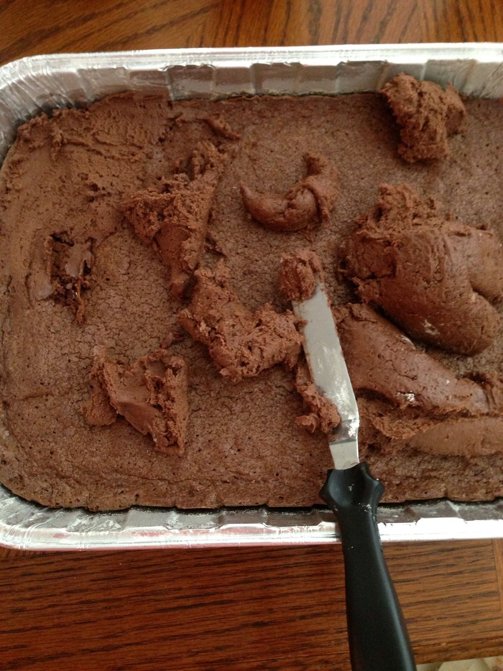 Distribute the frosting all over so the heat from the brownie can melt the frosting a bit. Lightly spread over the entire brownie.