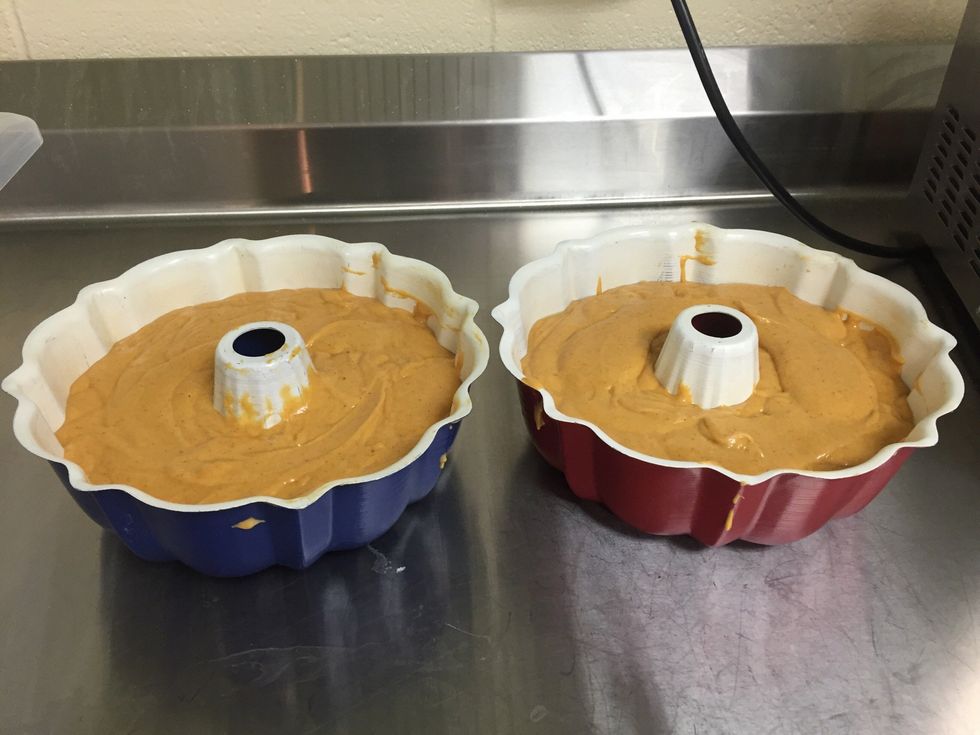 Divide batter between the two pre greased bundt pans
