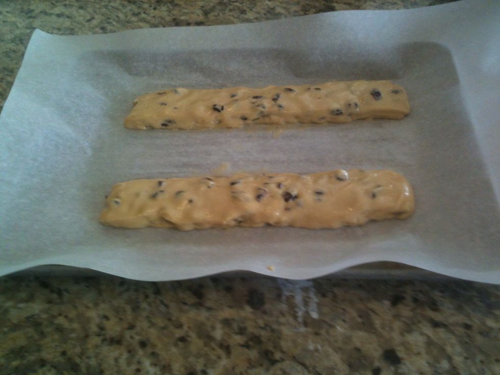 Divide dough in half. Form two logs on a parchment lined baking sheet. Dough will be sticky; wet hands with cold water to better handle the dough.