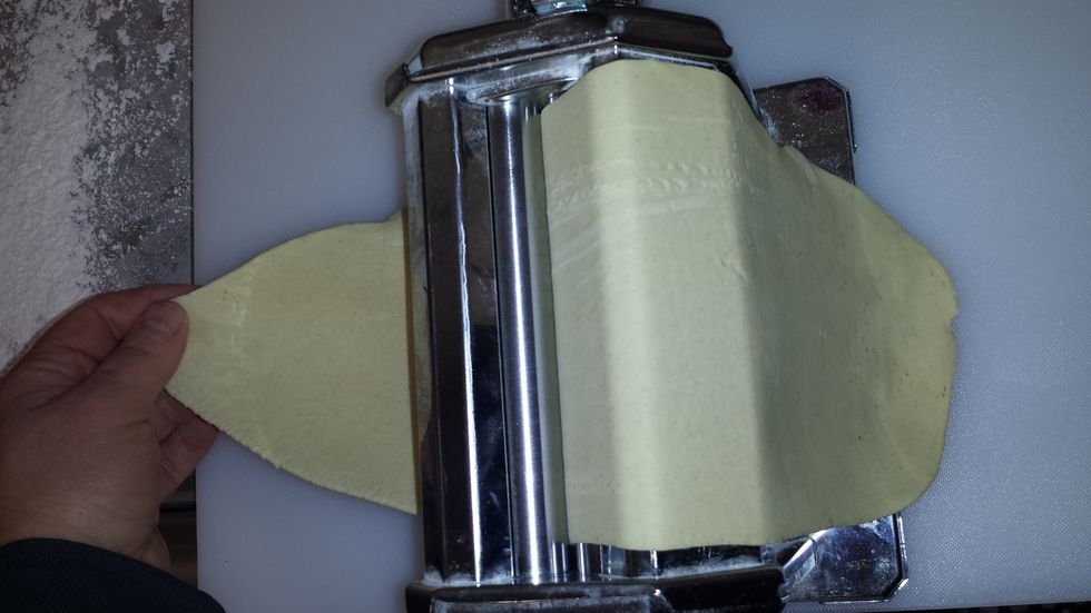 Divide into 4 balls and start putting them through the pasta roller, running them thru each level twice to prevent ripping. Take as thin as you want, second to the thinnest is ideal.