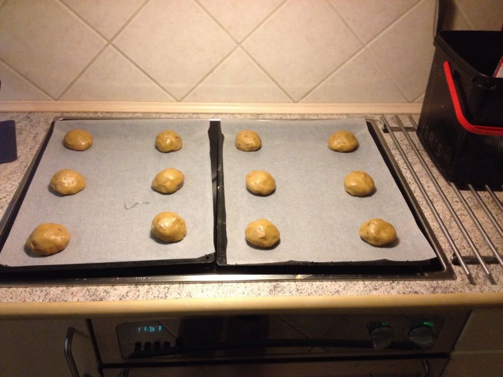 Divide the dough into twelve and place a piece of Mars bar in the middle. Shape the dough around the Mars into a large ball
