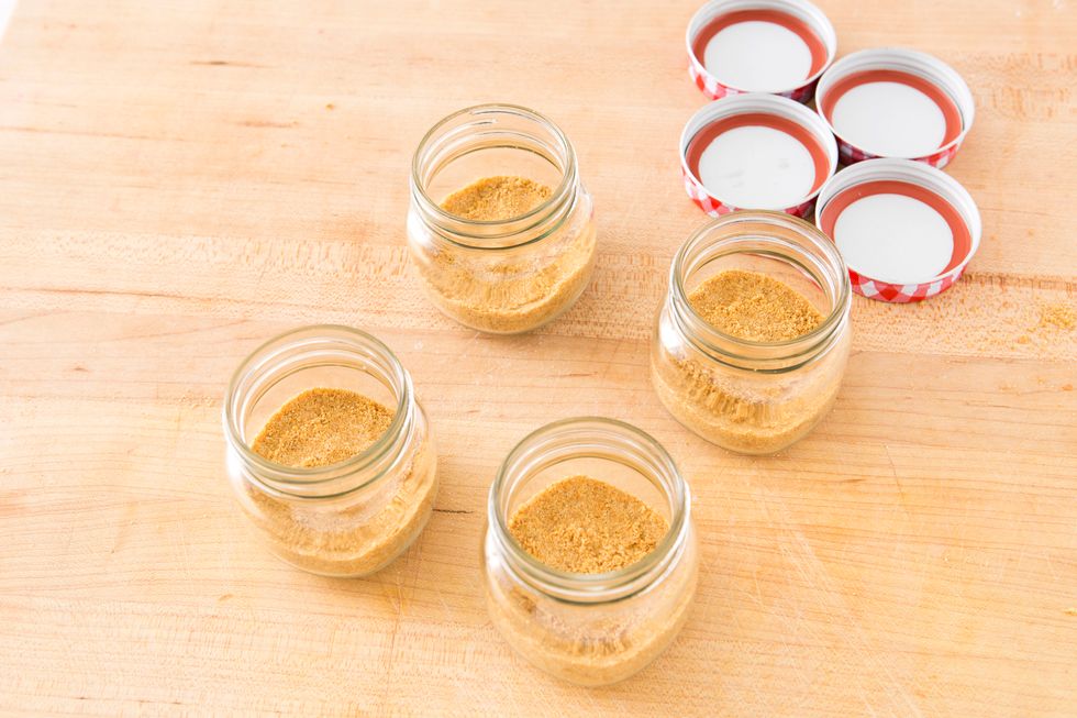 Divide the mixture into your jars, marking sure to press the crust to the bottom of the jar. We used a spoon to ensure it was pressed down all the way. Then, set aside.