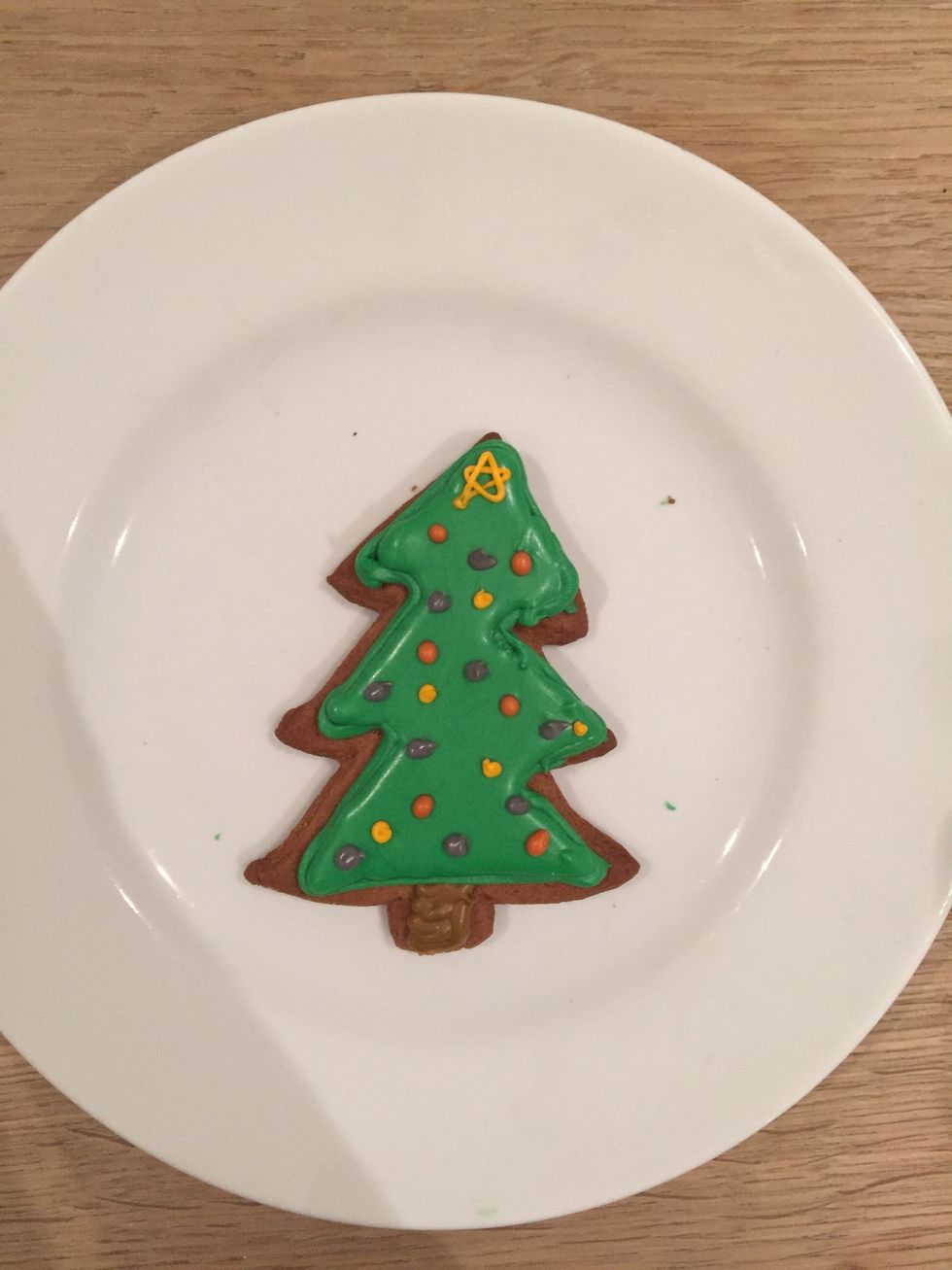 Divide the remaining icing into any colours you want for baubles and pipe it on. I did a star at the top of each tree as well.