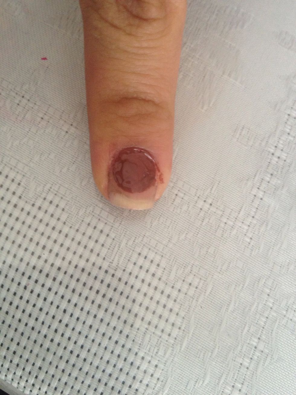 Do a big dark brown dot on one nail without nail polish