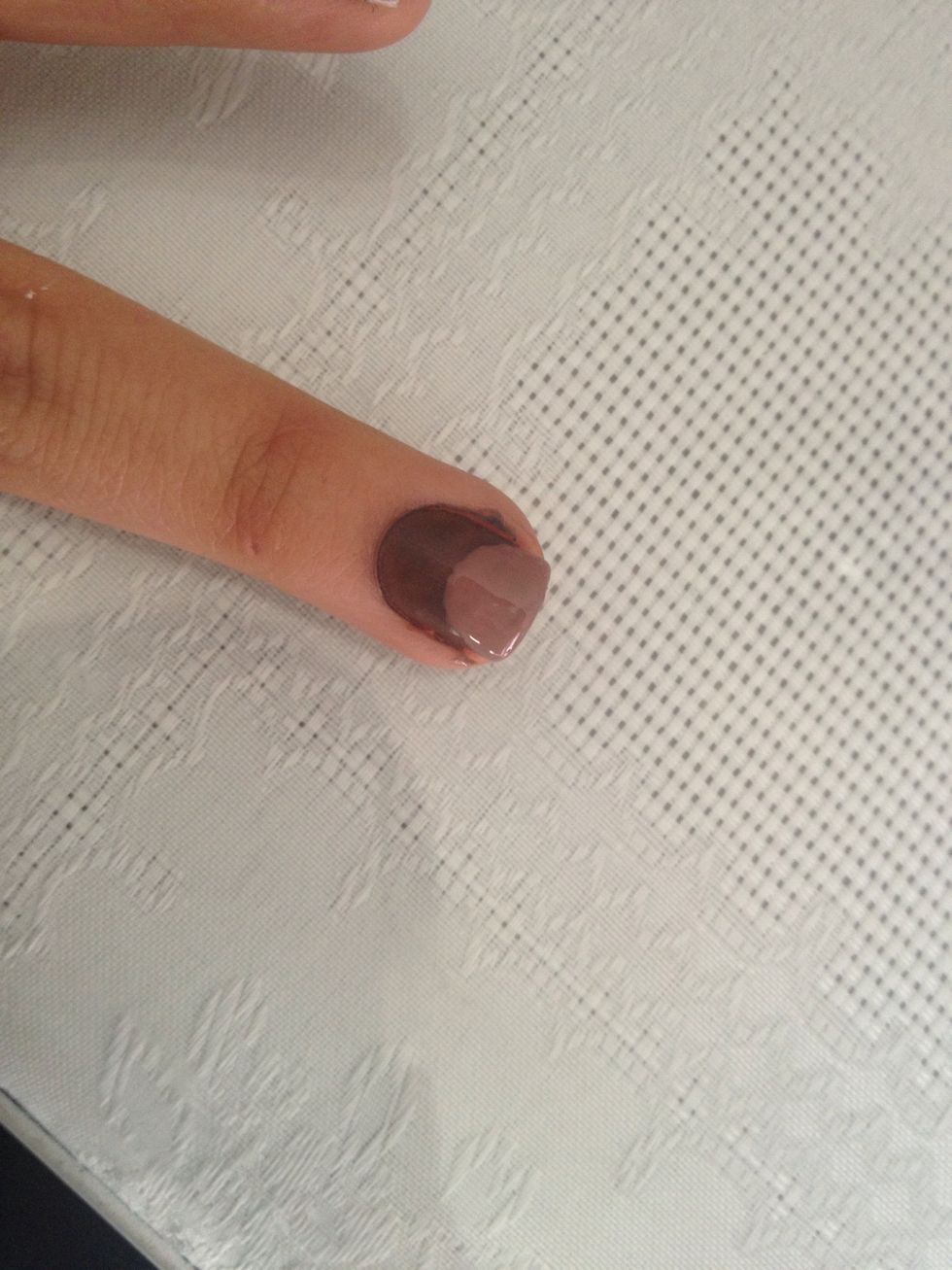 Do a big dot with the light Brown nail polish on the nail with the dark Brown