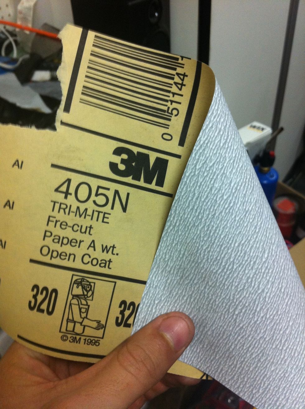 Do a quick, light sanding of the primer, then wipe it with a clean rag.