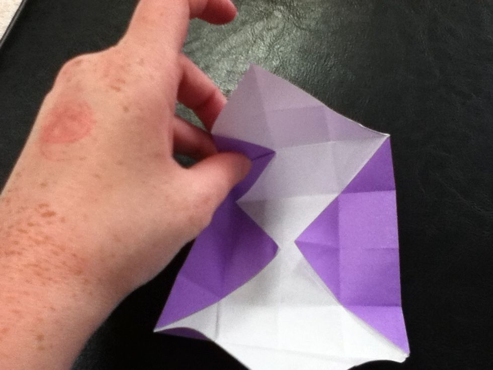 Do a reverse fold. Don't worry next is a video of the fold.