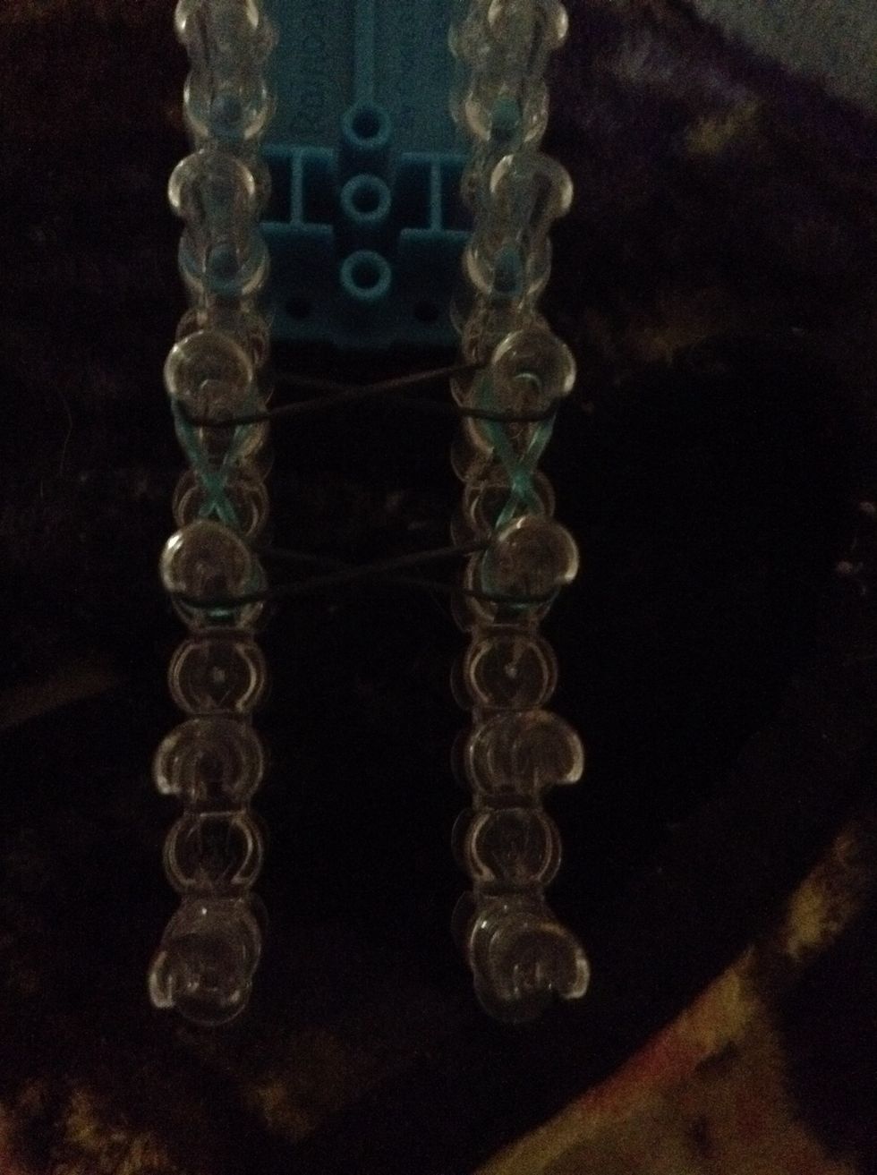 Do four little figure eights and stretch a band over all four pegs (will be shown in next step)