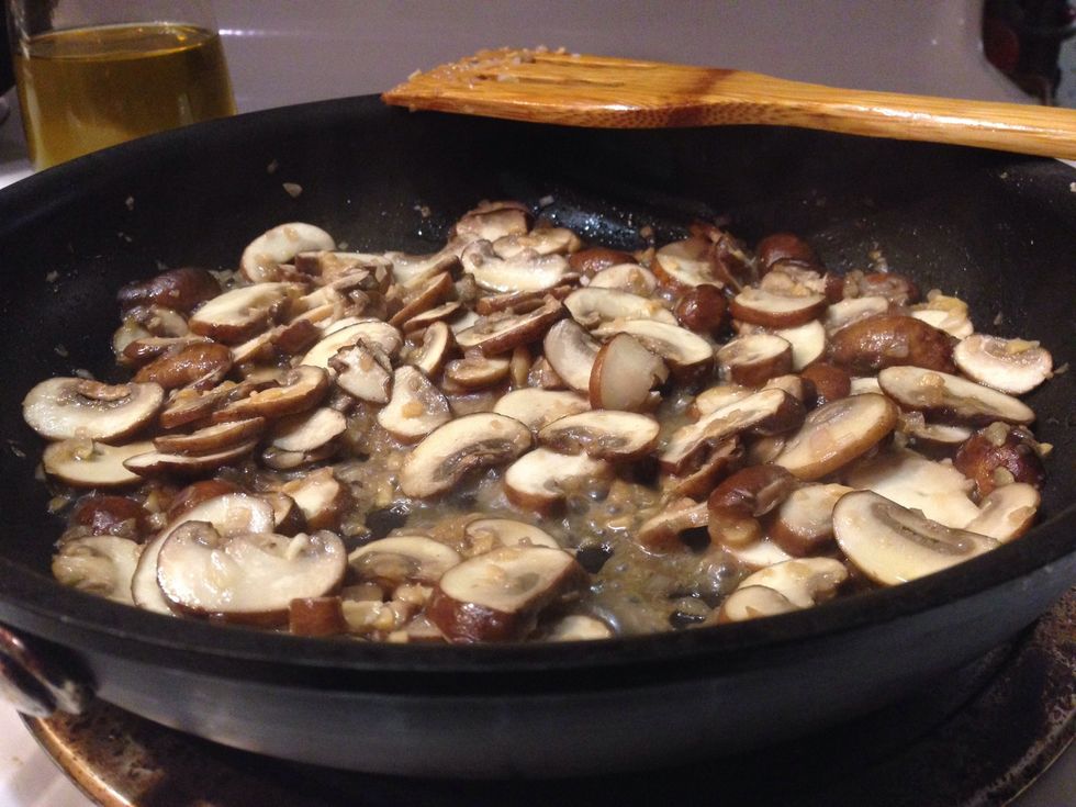 Do not cook with a lid on as you can see that the mushrooms release a lot of water and you want that to cook off.