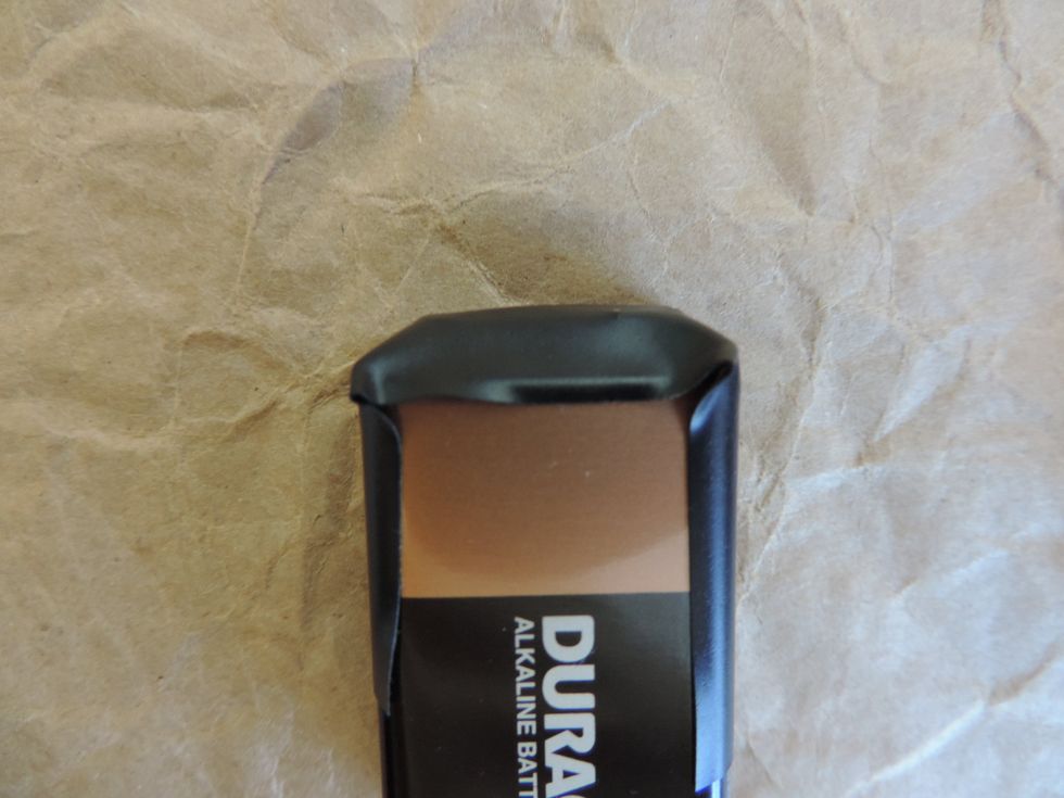 Do some folding of the tape to secure the area on top of the battery.