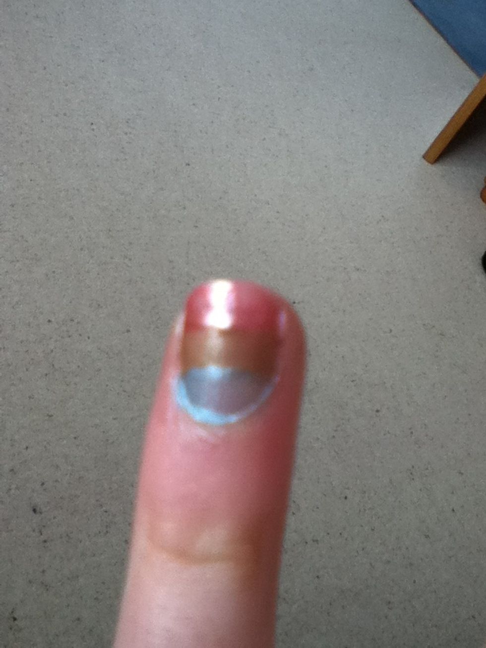 Do the same for the bottom third, cover the top and middle with tape, paint blue and remove the tape. Clear up around the edges with nail varnish remover. Done!