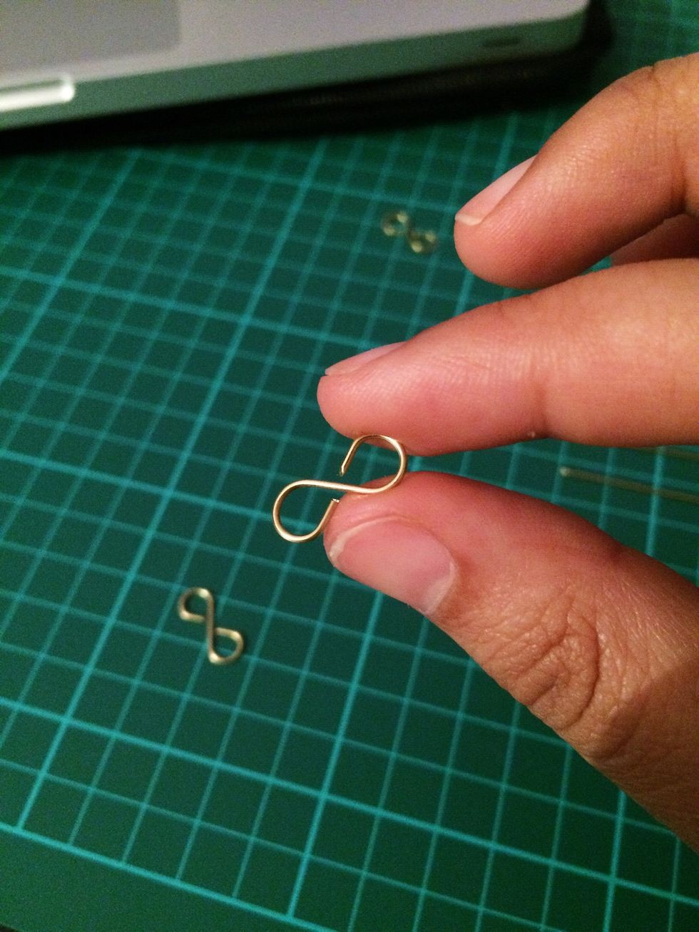 Do the same on the other end of the wire but wrap it in the opposite direction. You will end up with an infinity shaped link.
