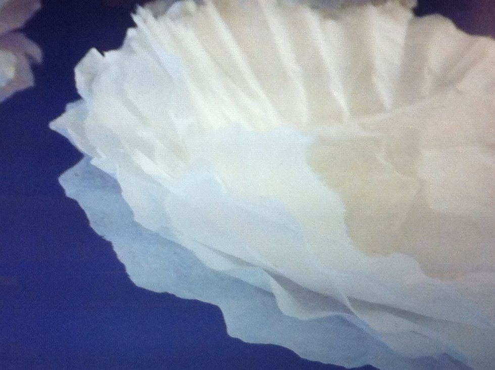 Do the same thing, but cut more off. And again, but cut less off. You want three different size flower bases.