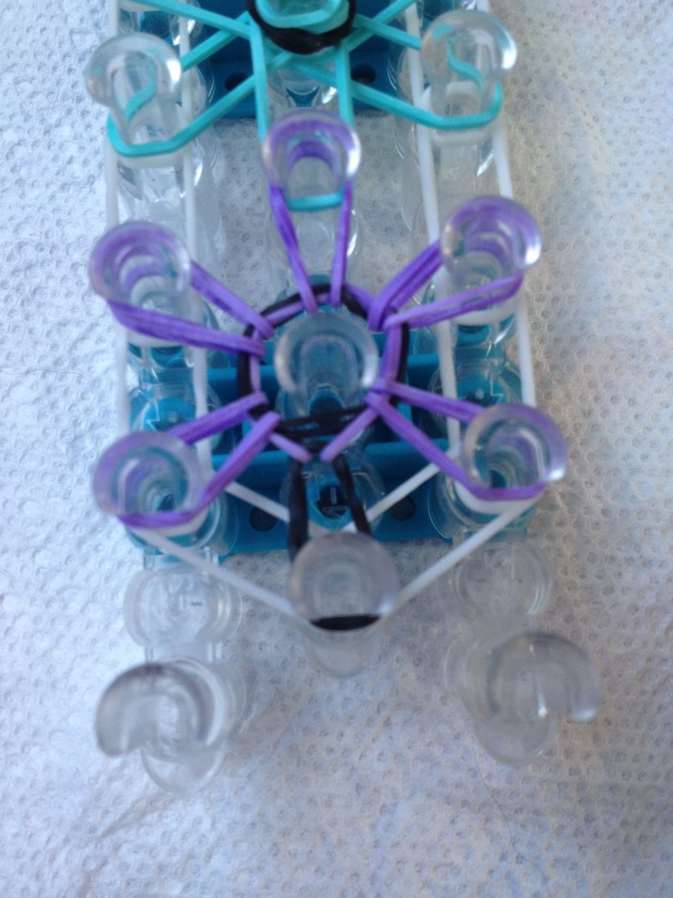 Do the same thing for the whole starburst. No bands should be left on the middle peg.