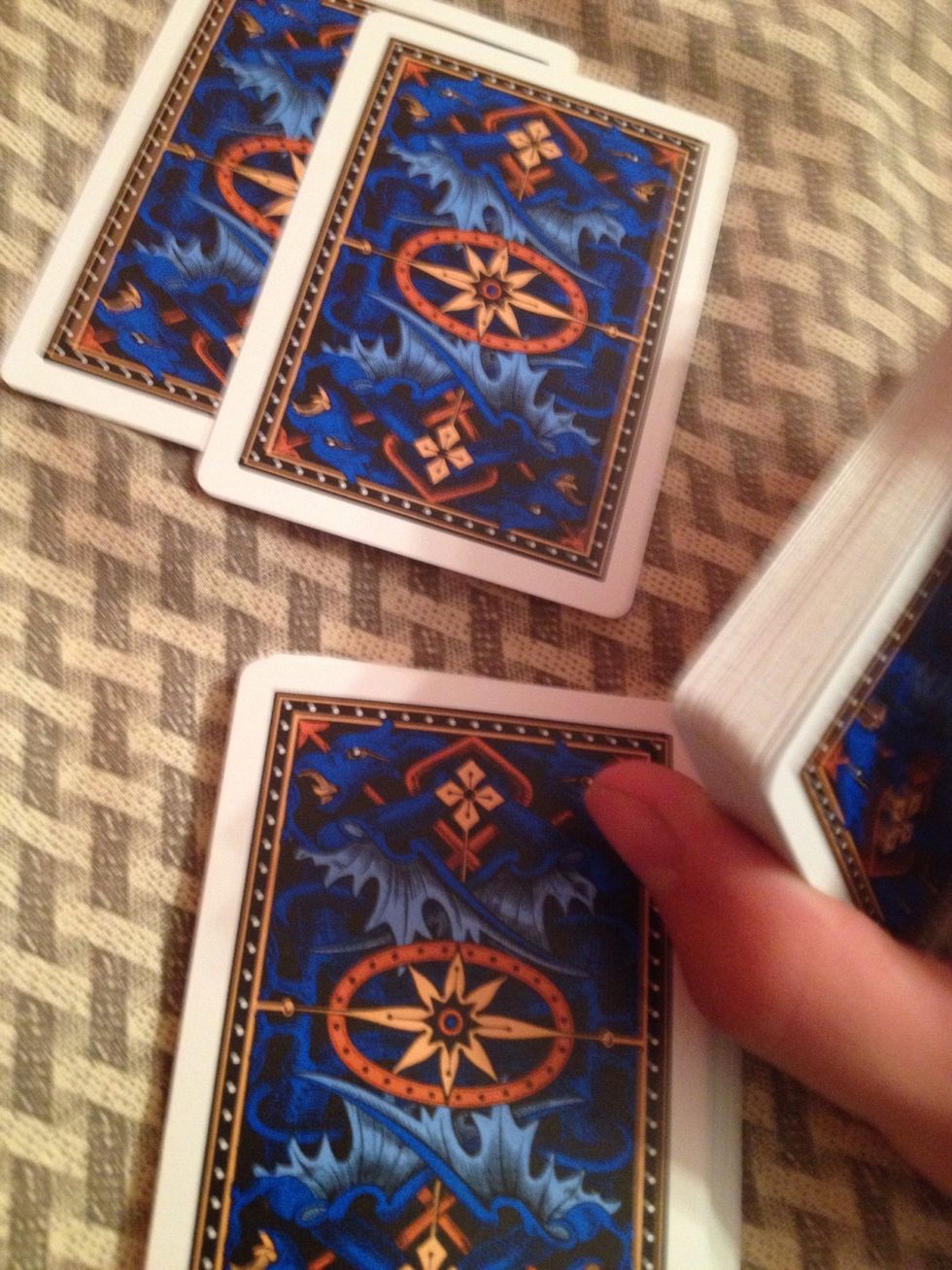 Do the same thing with the second card, but before you put it on the table put the two cards from the pinky break on top of it. Now you put the new top card on the table.