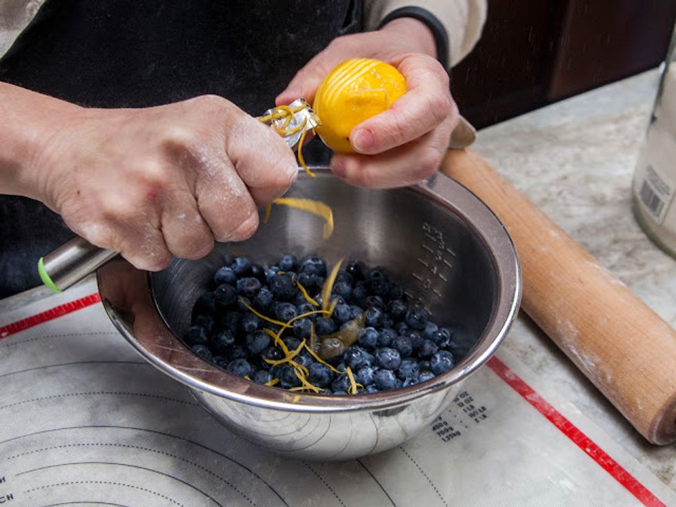 do this part while your tart dough is chilling.....In a large bowl mix together the blueberries with the lemon zest.