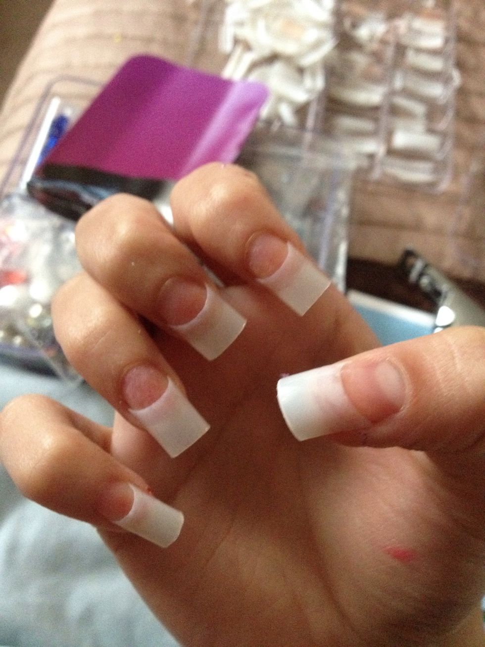 Do this to all of your fingers and trim to a length you desire. Also paint a coat of "ridege filler" on incase it's not completely flat, clear nail varnish is fine too.