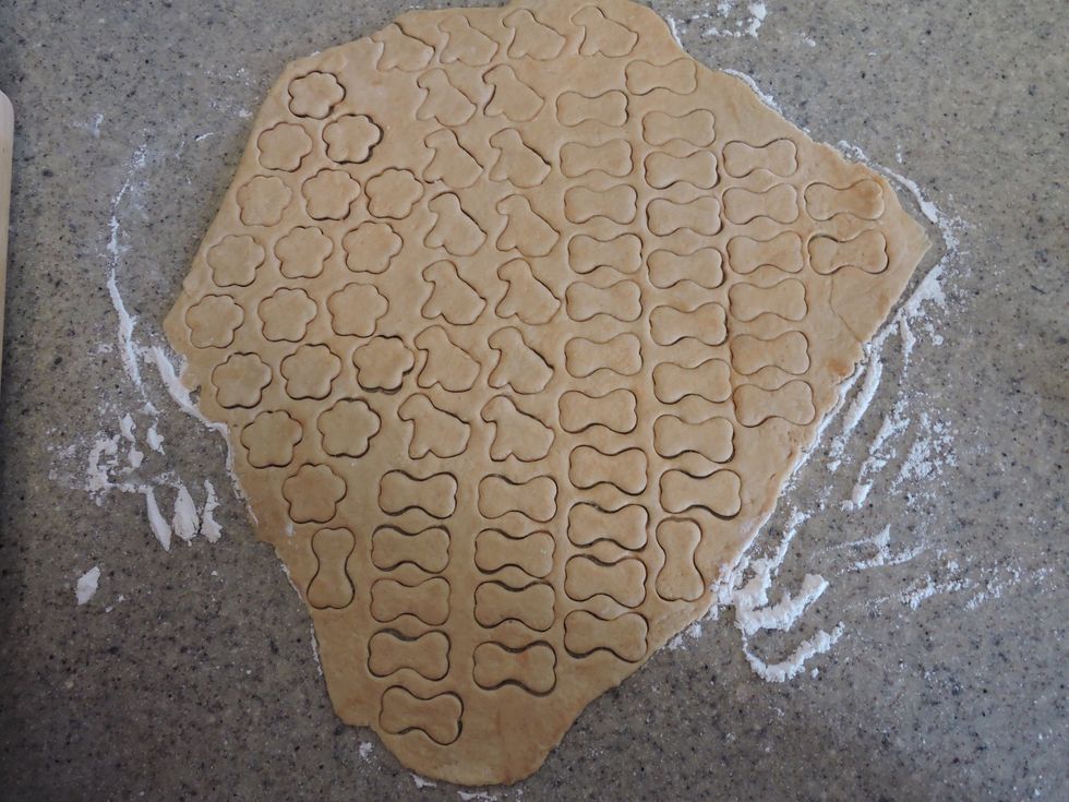 Do this to the rest of the dough, and then remove the excess dough around the cut-outs. Reform unused dough into a ball and roll out again for additional treats.
