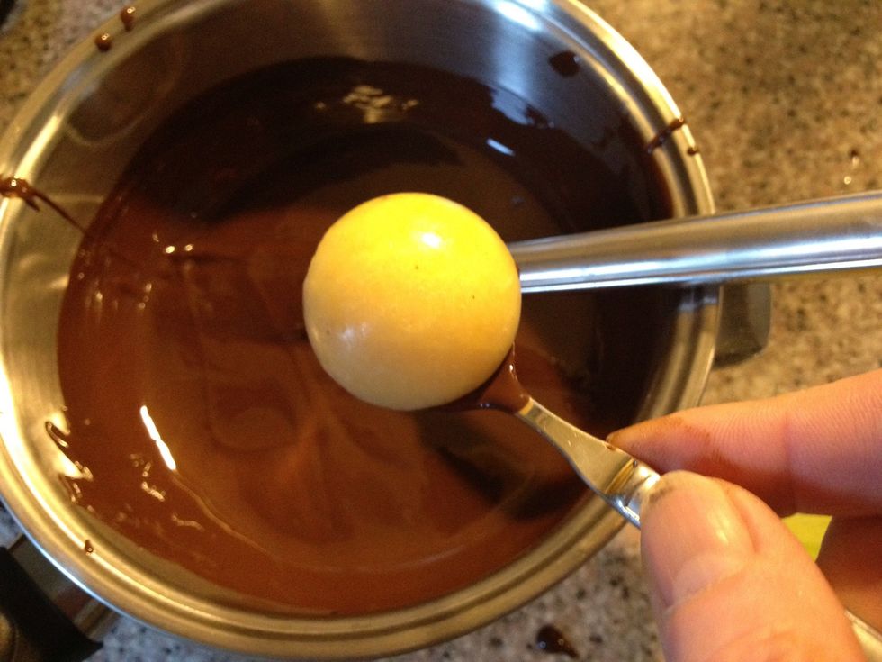 Don't dump the frozen juice into the chocolate, it will release water into the melted chocolate and that will ruin it. Use a spoon to pour the chocolate over the frozen juice.