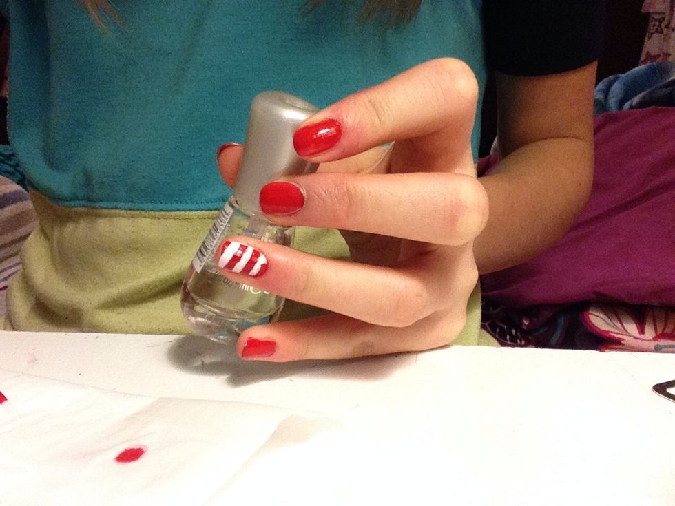 Don't forget the clear coat! This is important. Skip the ring fingers for this part if you want to add glitter. Paint the glitter coat on in the direction of the red stripes, or it will smudge.