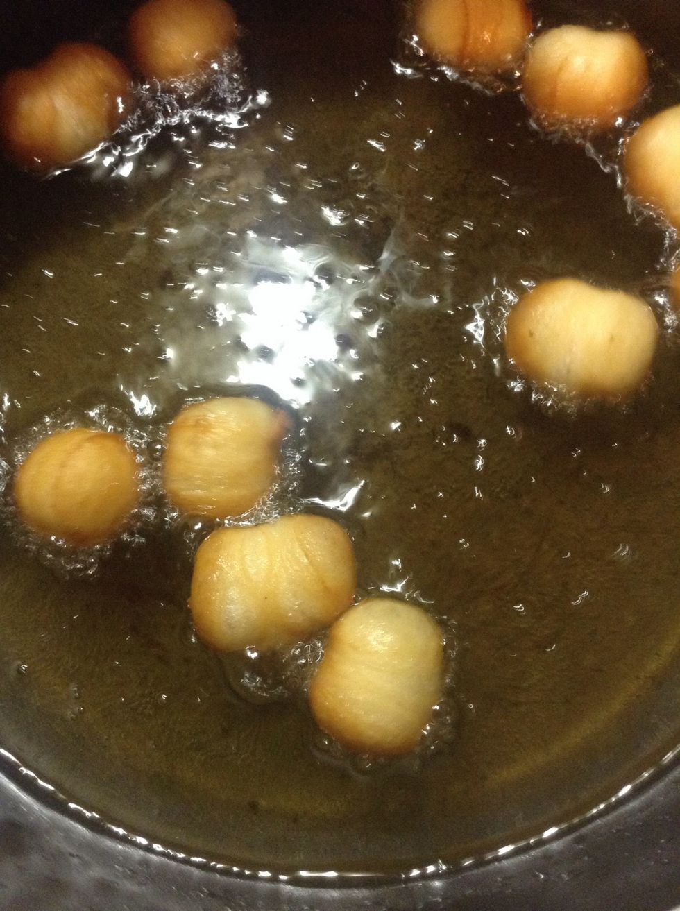Don't forget the holes! When they are done, roll them in powdered sugar and now you have a little snack while you finish your Cronuts!