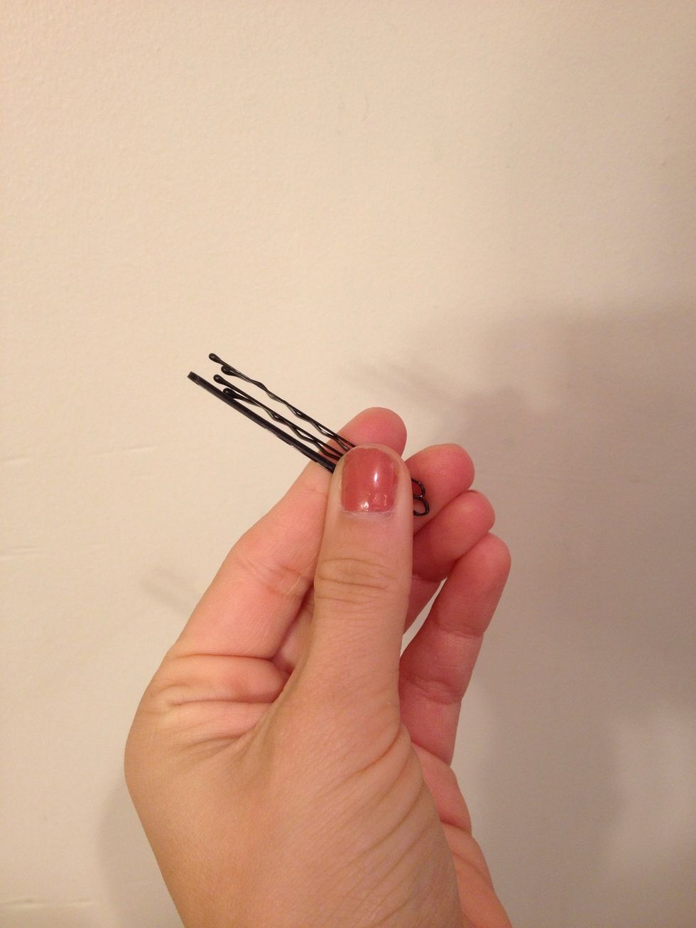 Don't let the hair drop from the iron. Gran it with your palm and roll it up it to a curl and bobby pin it to your head. Repeat this process for the rest of your hair.