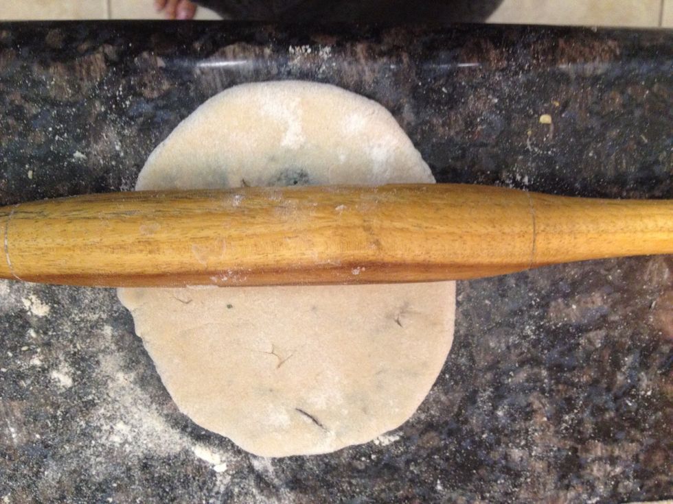 Don't press too hard with the rolling pin or the potatoes come out of the dough. 1ce you do a couple you will get the hang of it.