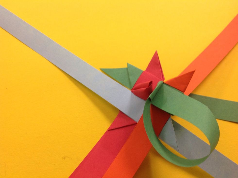 Done correctly, the paper will feed out of the center of the triangle of the SAME strip of paper.