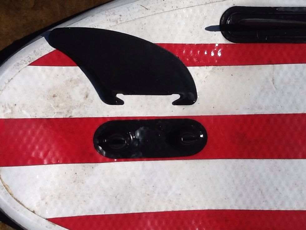 Double-fang fin - this photo shows the two "fangs" of the fin that need to catch onto the board.  The board MUST be deflated in order to put on the fin. A fang may snap so be careful.