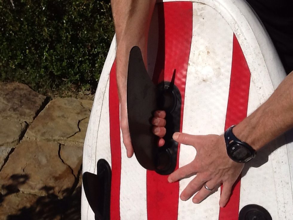 Double Fang - Step 4 - put your hand under the fin and give it a little tug to make sure both "fangs" have caught and are secure.  Reverse Steps 2&3 - making a crease between the knobs - to remove.