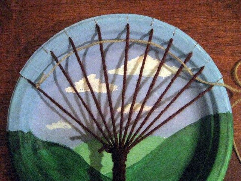 Double knot a chosen color to a tree branch on the end. Then weave LOOSELY over & under the branches. When you are ready to add a color, cut the colored yarn & double knot the end to an end branch.