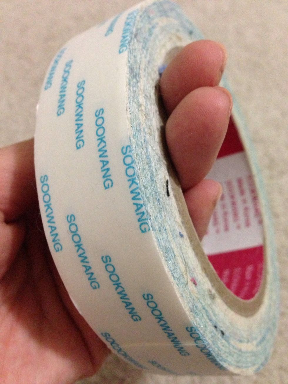 Double stick tape is ideal! You can use hot glue gun as well but I imagine you would have to work fast, since the glue hardens quickly.