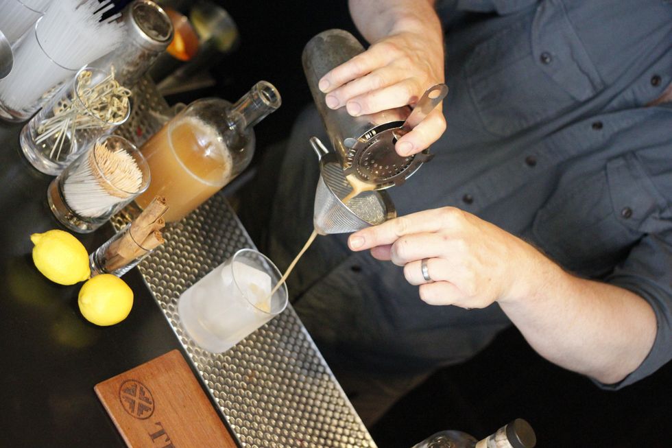 Double strain through a fine meshed sieve and pour into a chilled Old Fashioned glass with a large ice cube