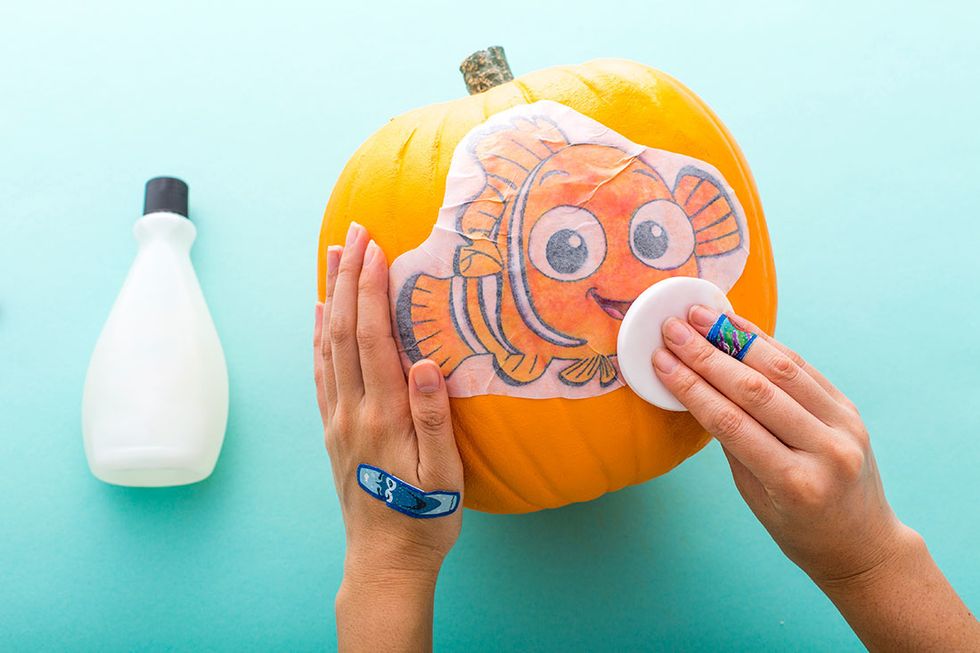 Download an image of a clownfish from the web. Print it full page, then transfer the image using nail polish remover and a sponge.