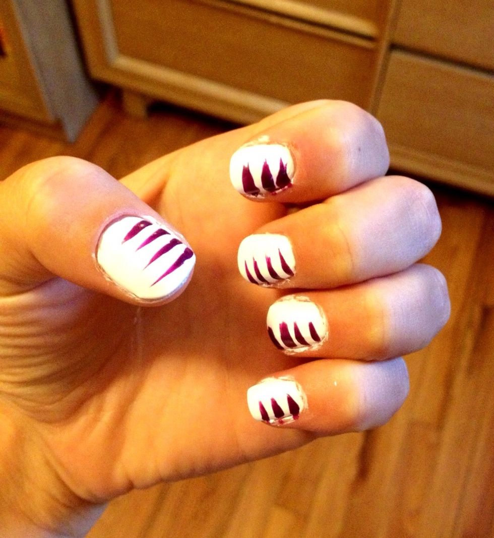 Drag purple striper halfway across nail to create stripes on one side of each nail. Make sure to leave small spaces between stripes