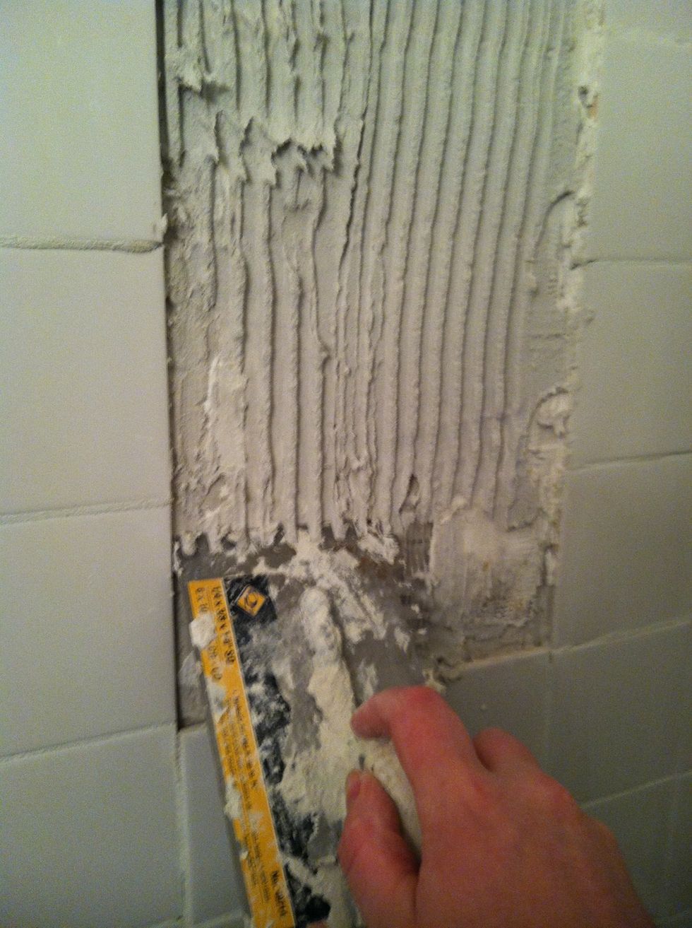 Drag ribbed edge along mortar to create notches.