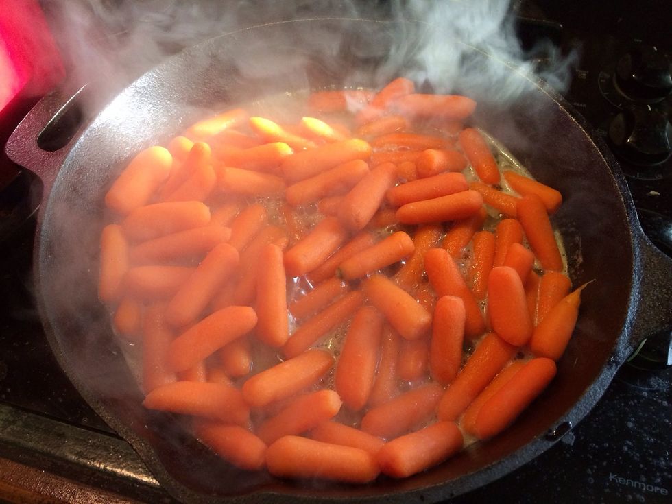 Drain about half the water out out the boiling carrots and add to the pan with brown sugar and butter. Mix to coat and cook for about 3 minutes, stirring occasionally. I add half the bourbon now.