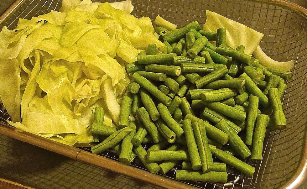 Drain and dry the blanched cabbage and long beans.