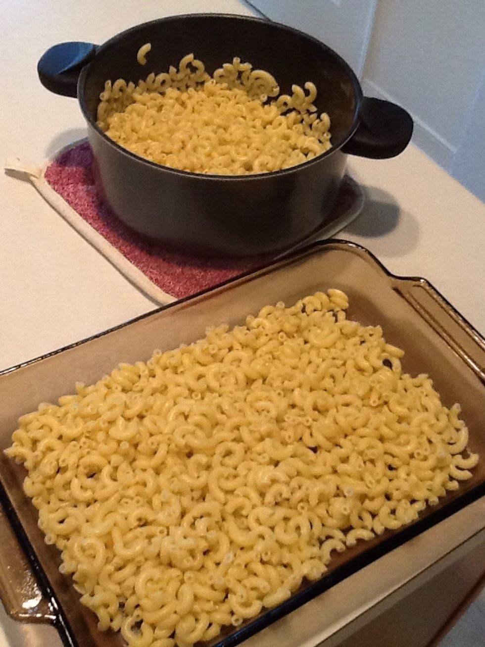 Drain macaroni.  Pour half of the pot into the dish.