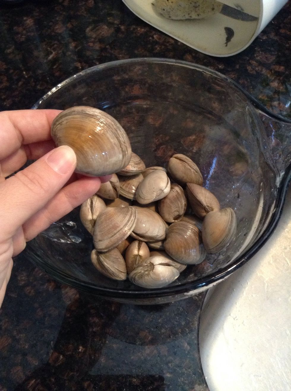 Drain off the clams & inspect for any cracks or open clams. If so, toss those broken/open clams in the trash.
